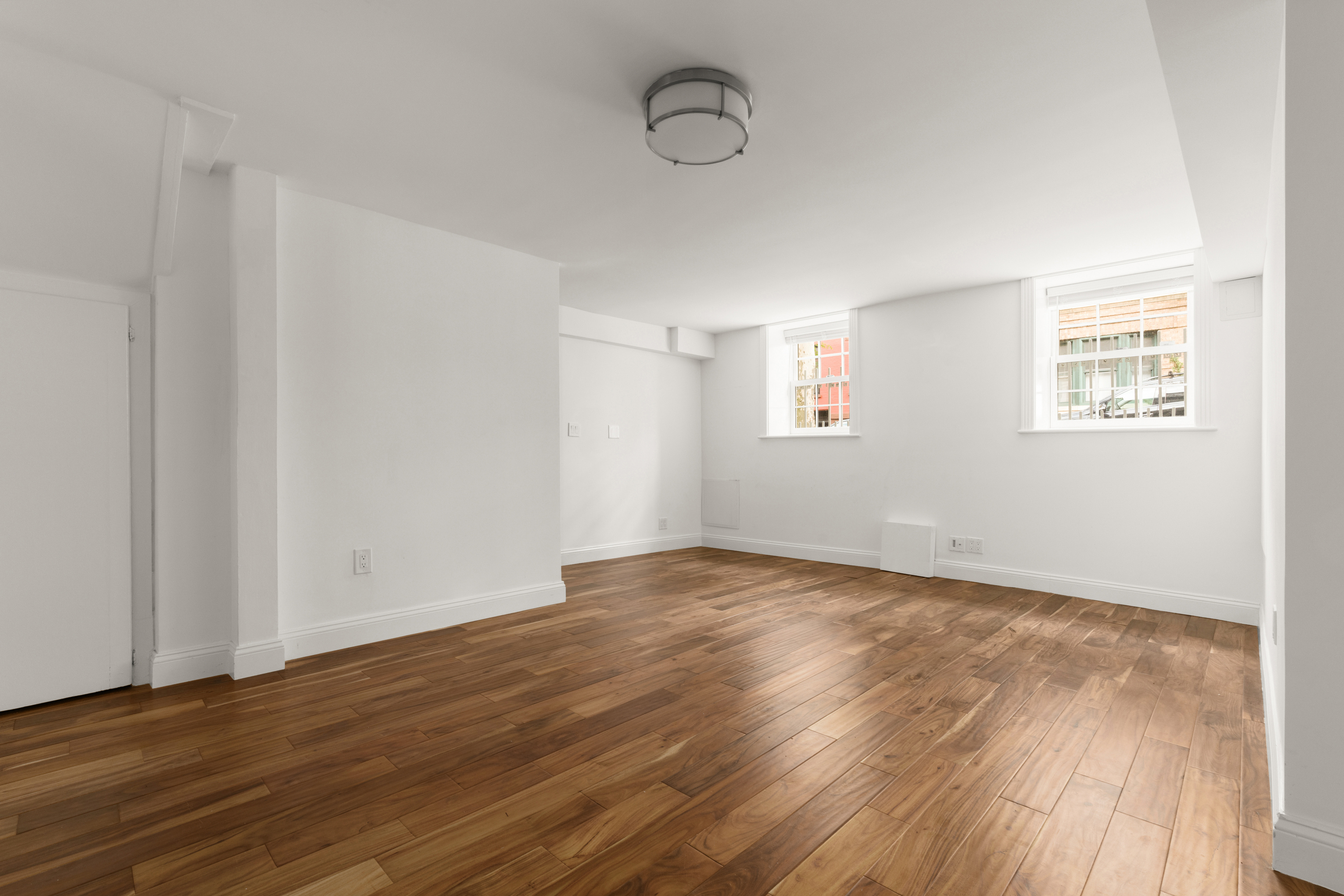 60 Hicks Street Brooklyn, NY 11201 - Photo 18 of 22 a view of an empty room with wooden floor and a window