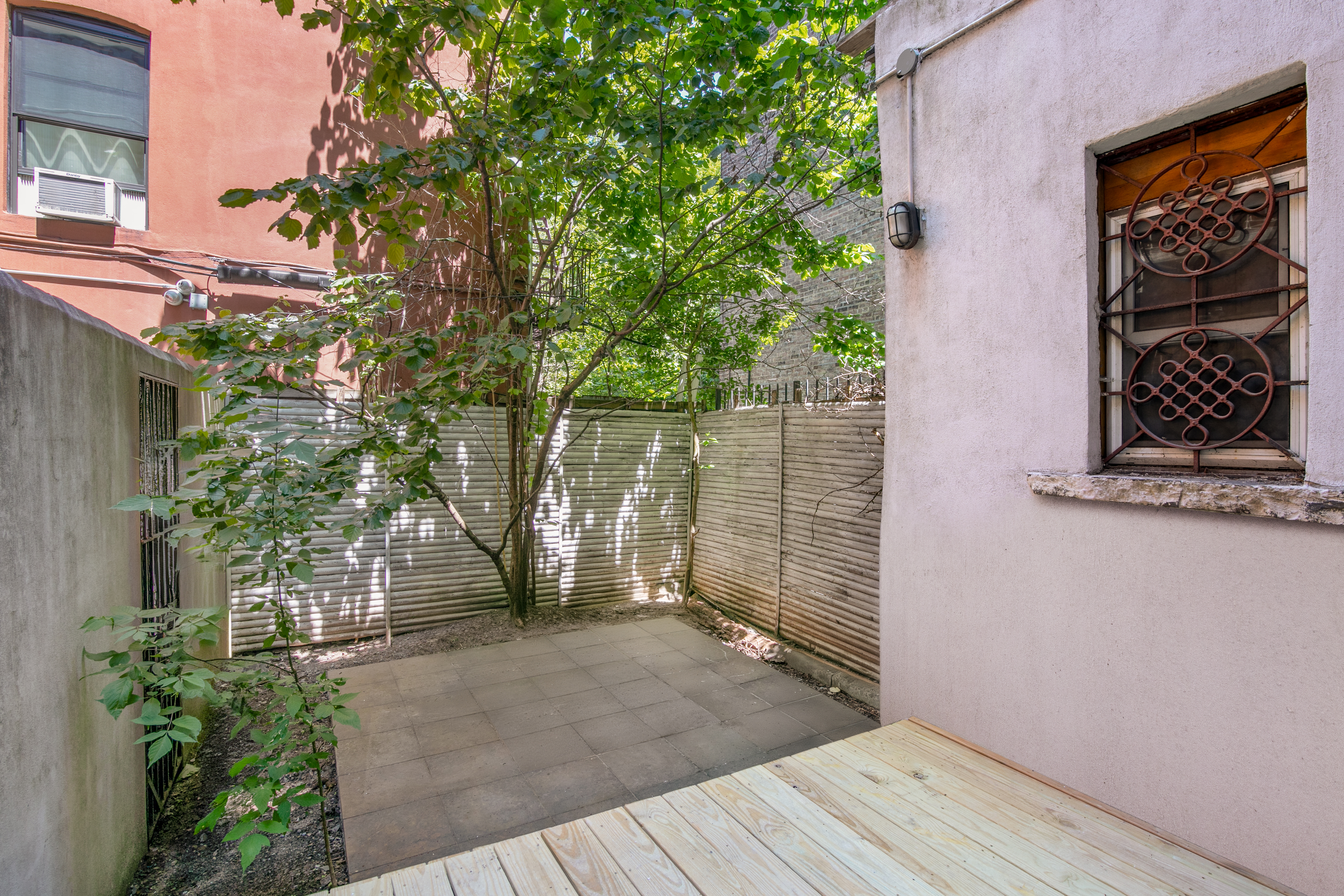 305 East 4th Street, Unit GARDEN Manhattan, NY 10009 - Photo 3 of 8 a backyard of a house with lots of green space