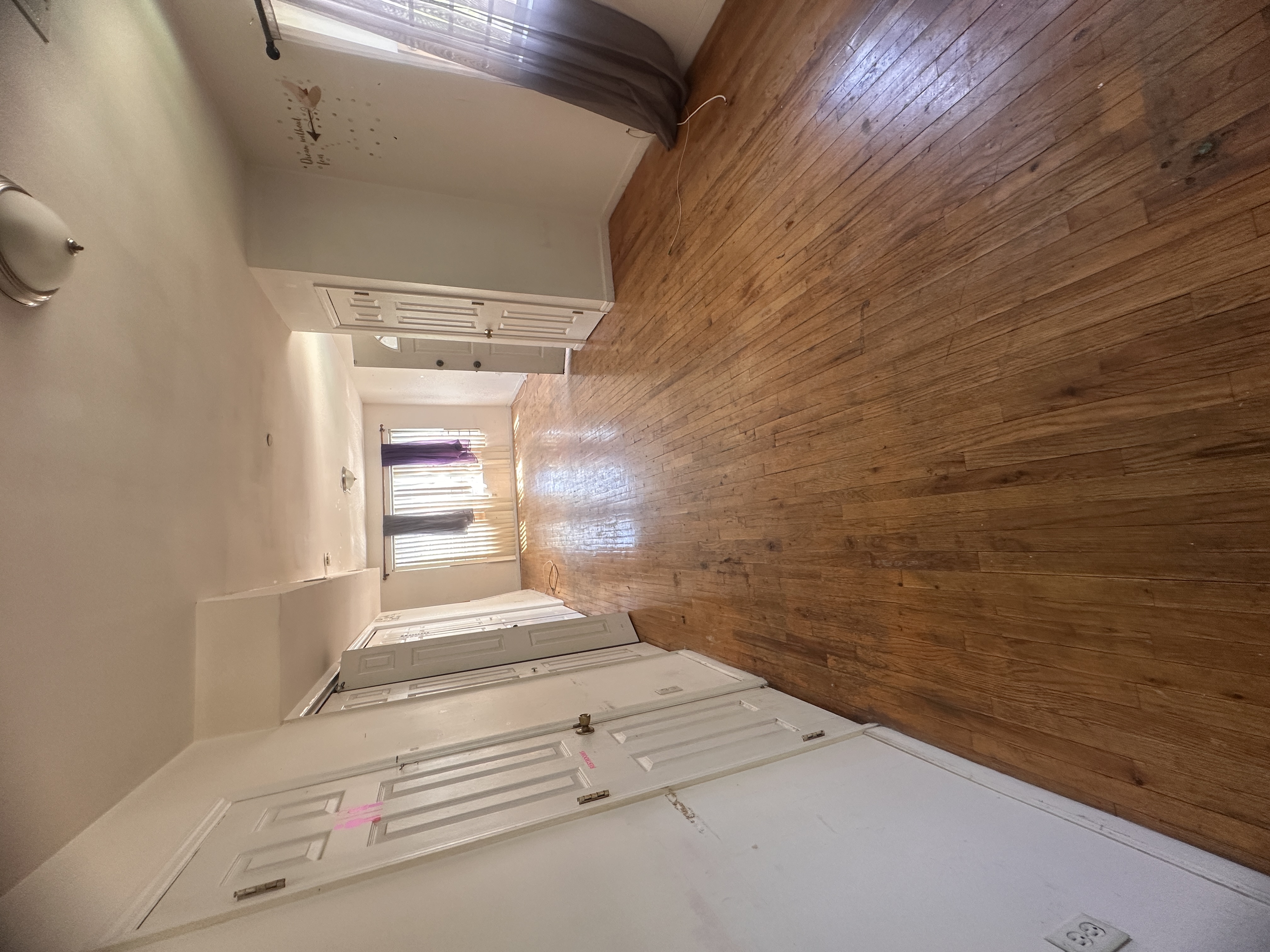 165 Brighton Avenue Staten Island, NY 10301 - Photo 3 of 8 a view of wooden floor in an empty room