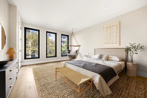 a bedroom with a large bed and a large window