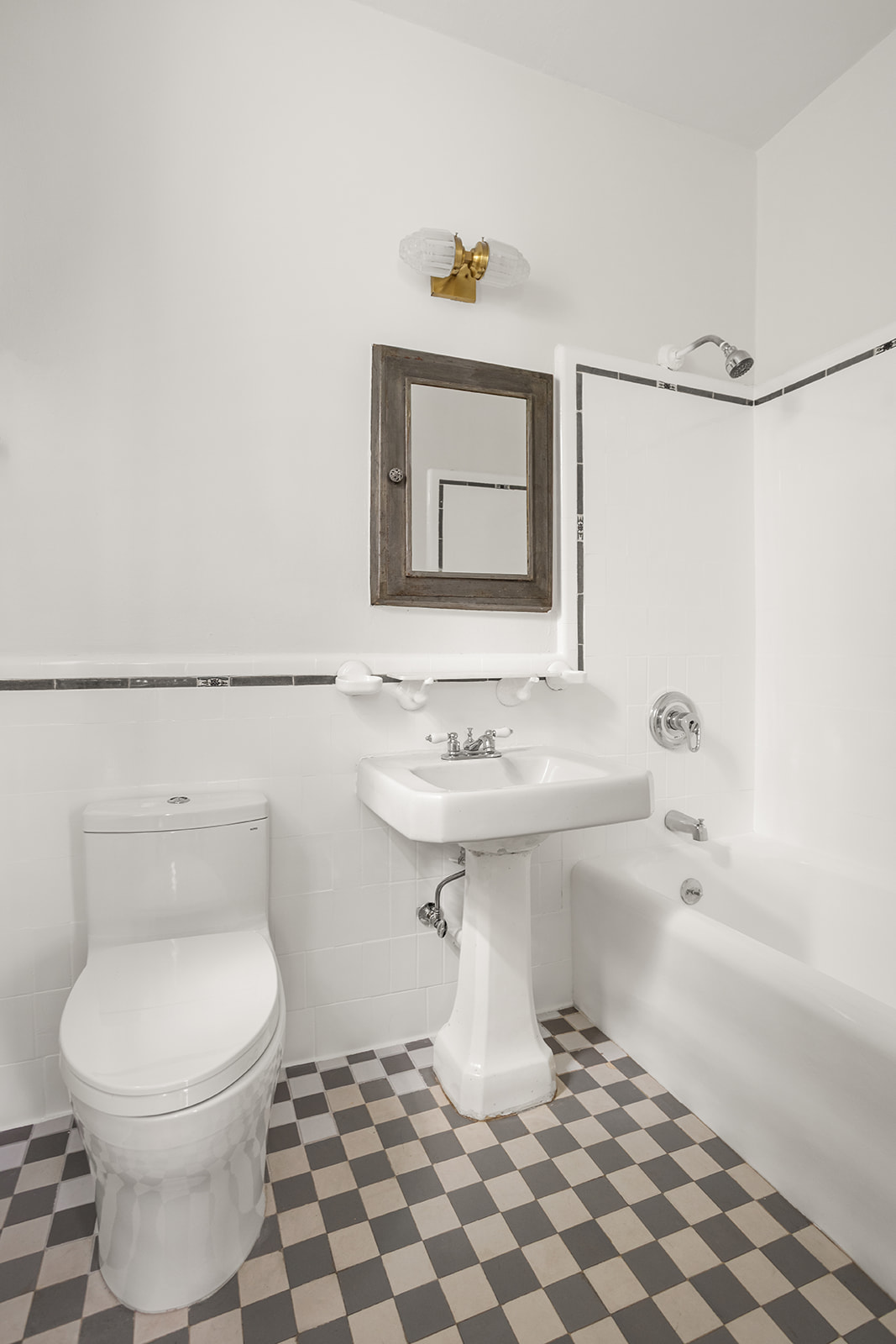 33-39 80th Street, Unit 2 Queens, NY 11372 - Photo 8 of 19 a bathroom with a sink a toilet and mirror