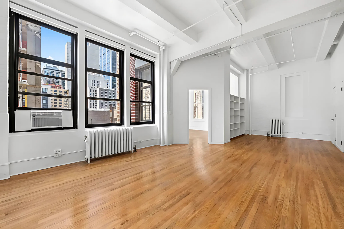 448 West 37th Street, Unit 6H Manhattan, NY 10018 - Photo 2 of 9 a view of an empty room and window