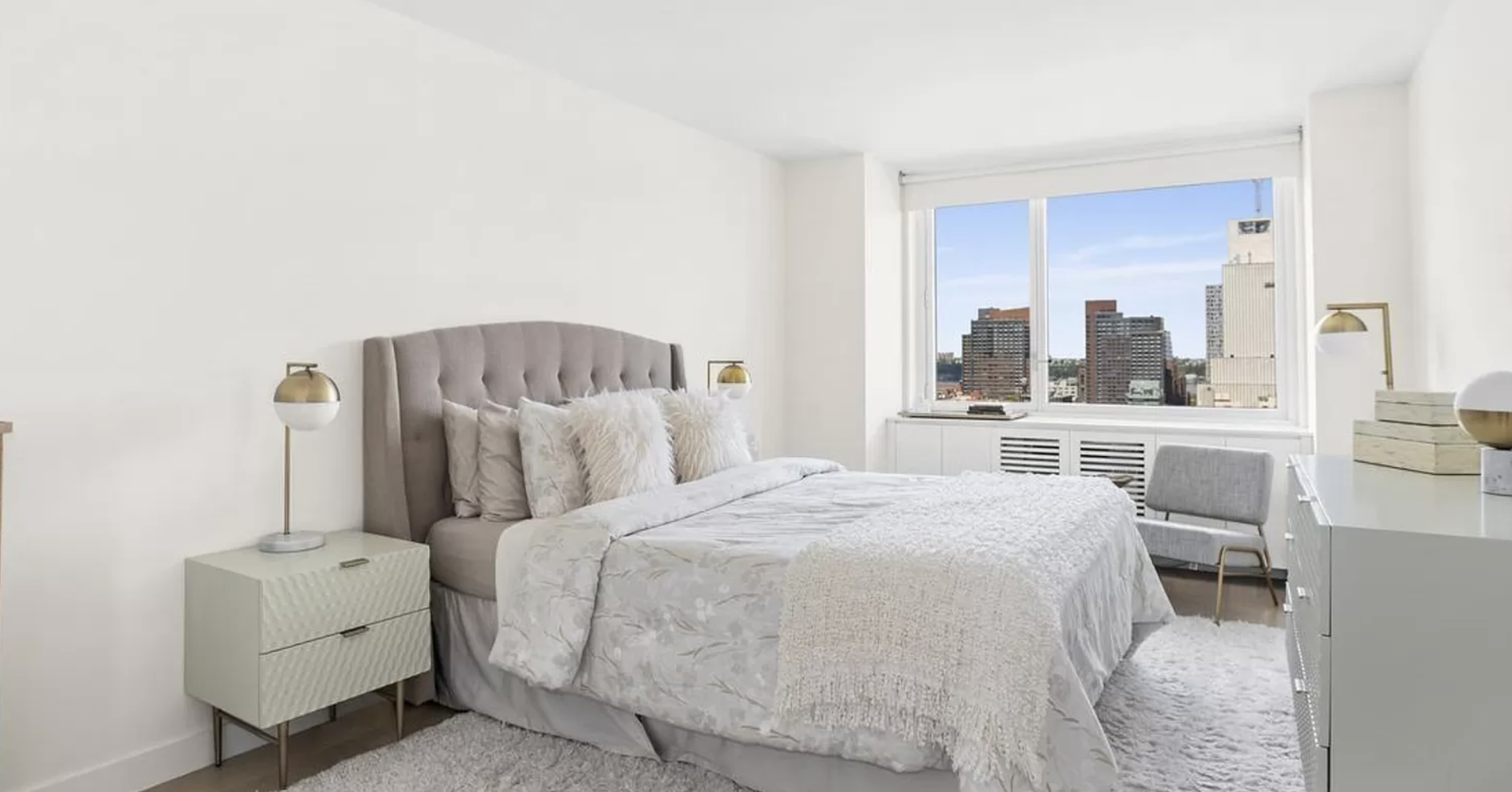 301 West 53rd Street, Unit 14C Manhattan, NY 10019 - Photo 4 of 12 a bedroom with a bed and a large window