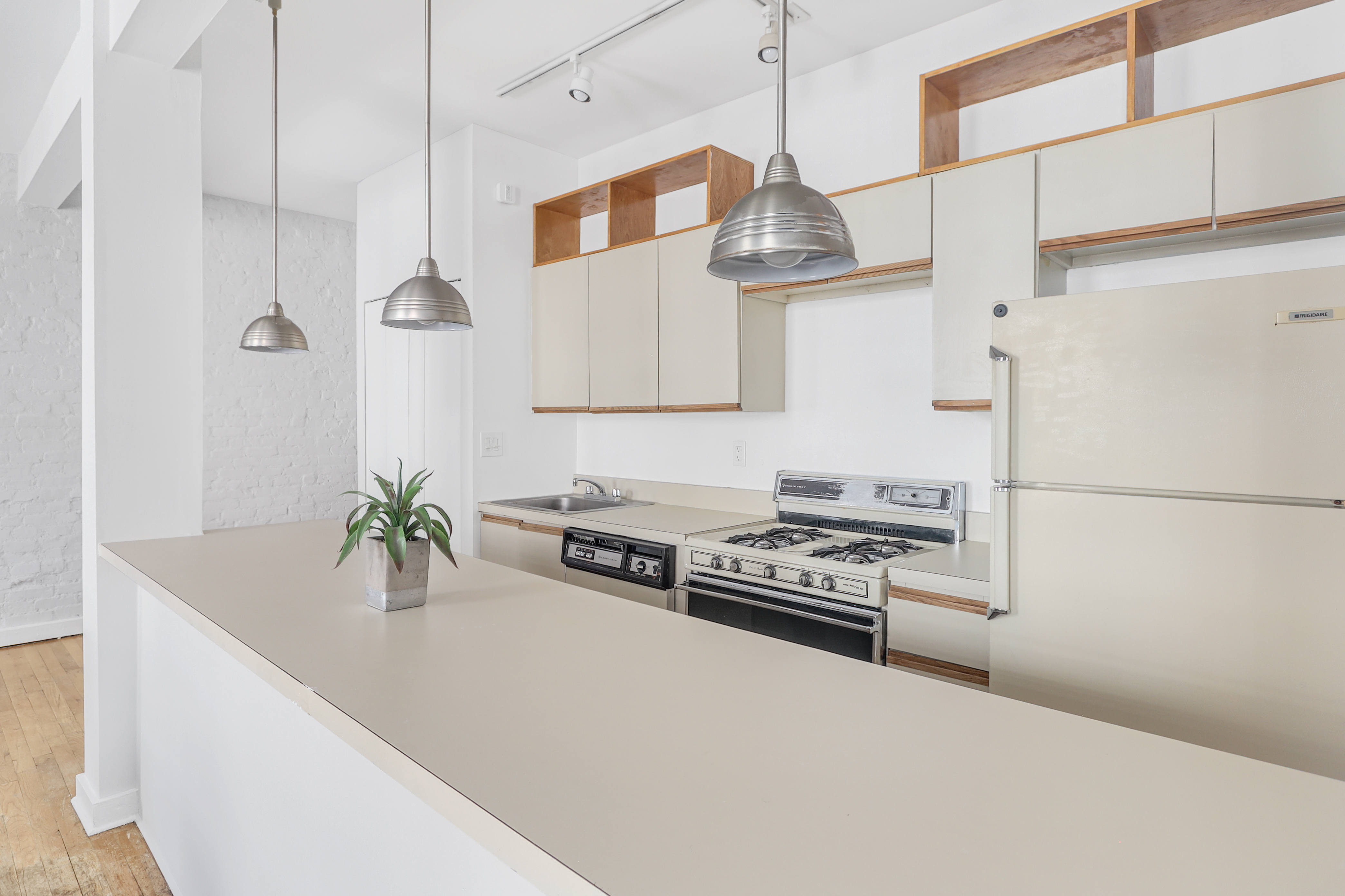 314 West 94th Street, Unit 5D Manhattan, NY 10025 - Photo 5 of 13 a kitchen with stainless steel appliances a counter space and a refrigerator