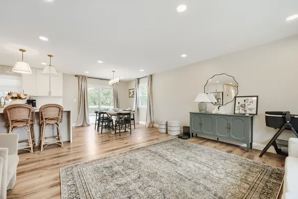 a living room with furniture a dining table and a fireplace