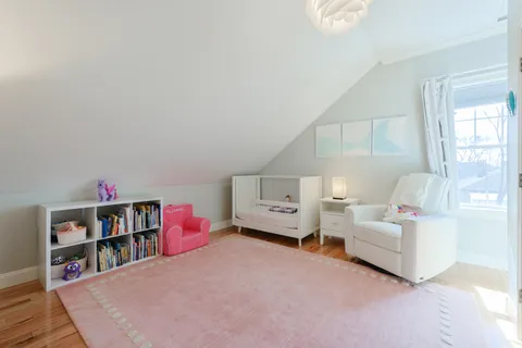 a living room with furniture and a book shelf