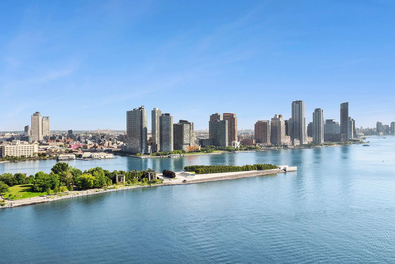 a view of a city with tall buildings and a lake view