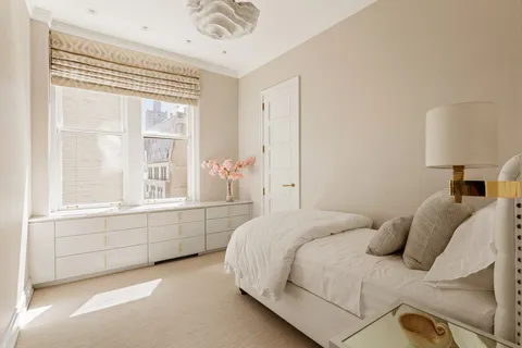 a bedroom with a bed and a window with outer view