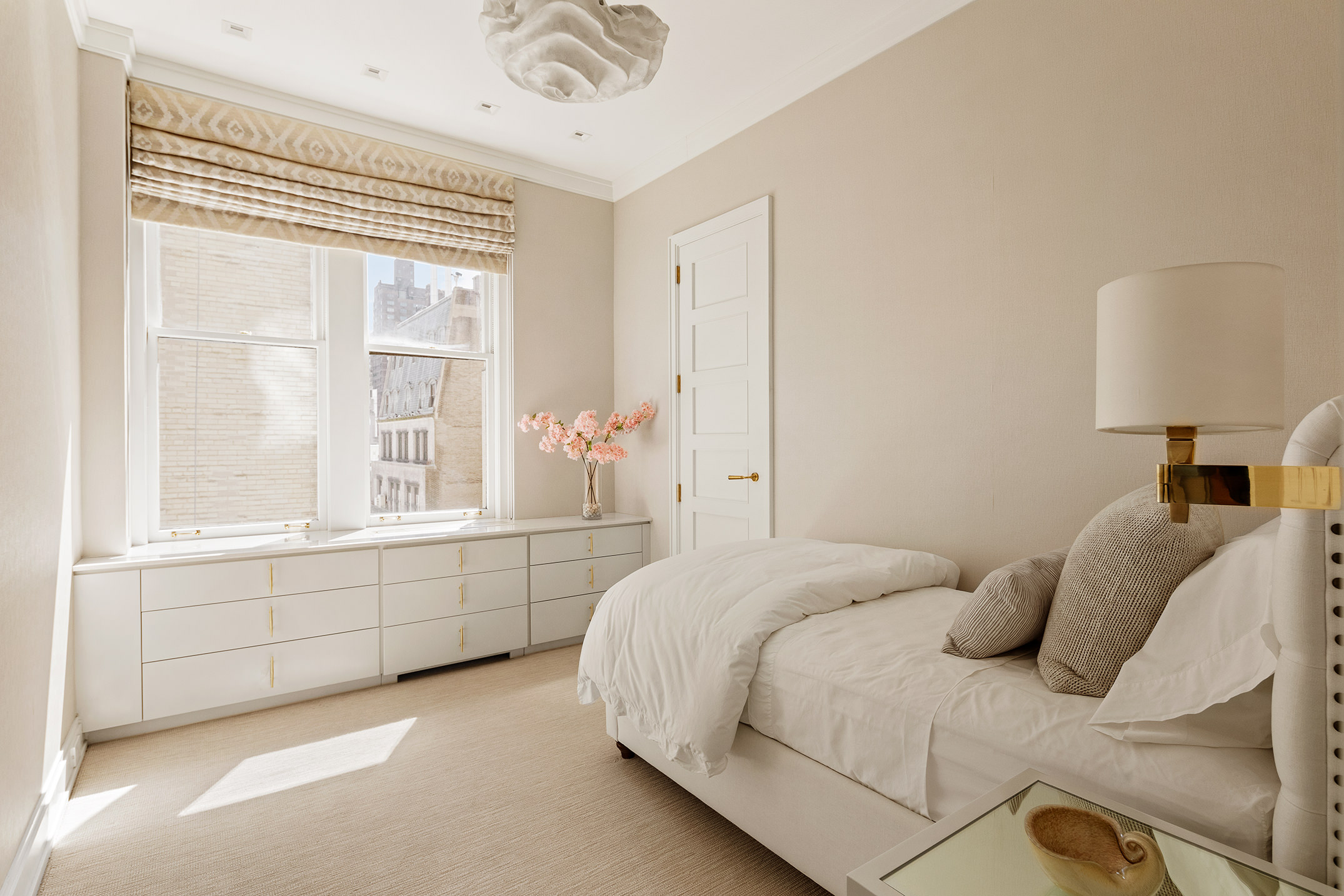 907 5th Avenue, Unit 7A Manhattan, NY 10021 - Photo 8 of 18 a bedroom with a bed and a window with outer view