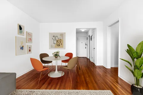 a dining room with furniture and wooden floor