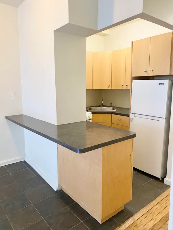 a kitchen with stainless steel appliances a refrigerator a sink and a stove