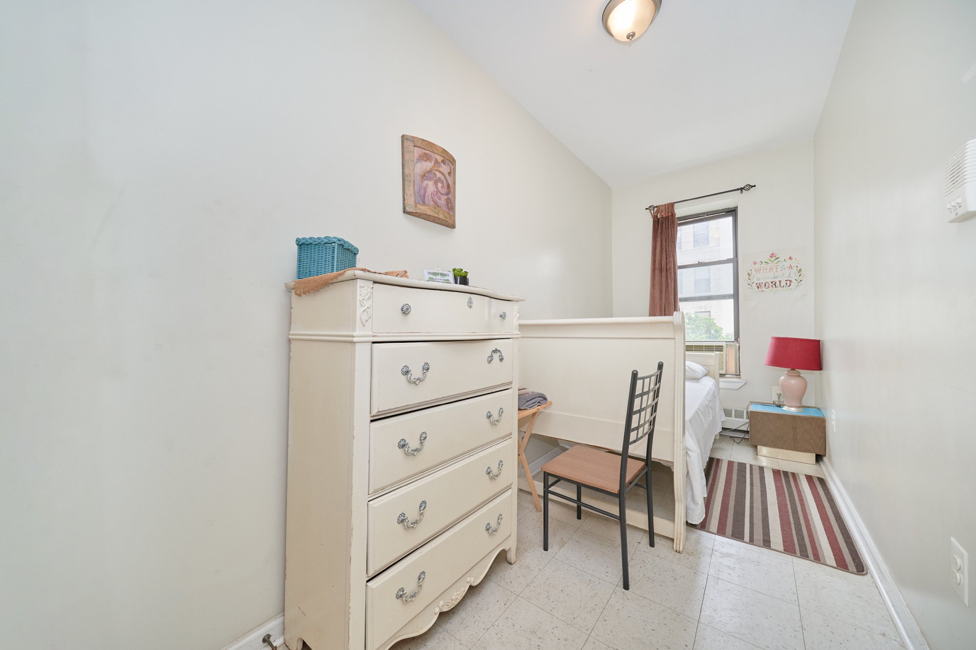 197 Edgecombe Avenue Manhattan, NY 10030 - Photo 7 of 12 a bedroom with a bed and a cabinets