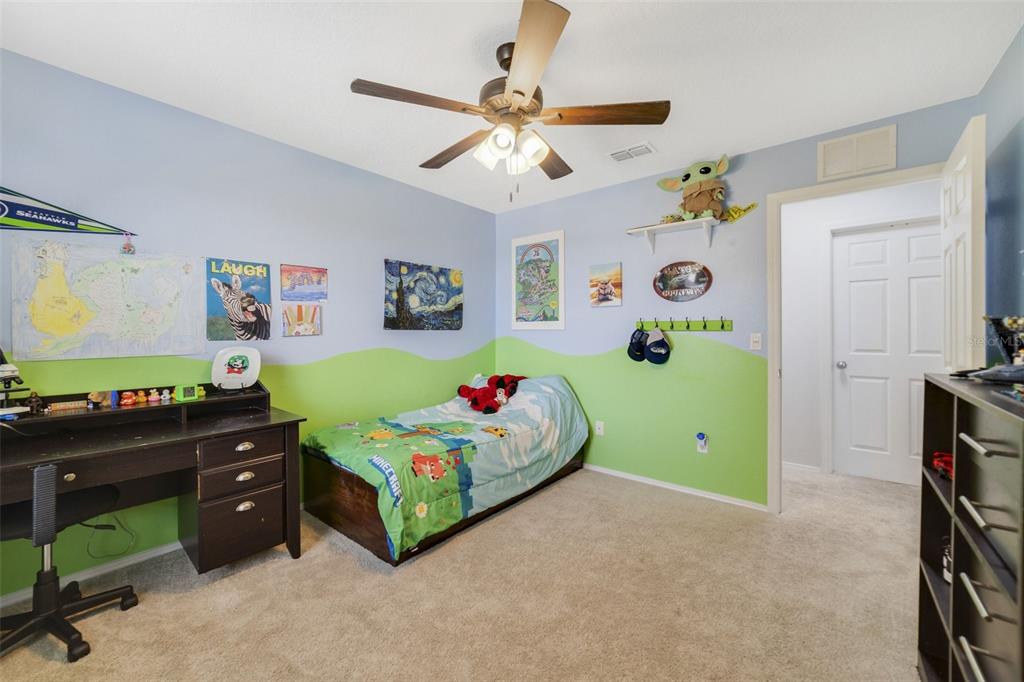 352 Giovani Boulevard Clermont, FL 34715 - Photo 31 of 46 a bedroom with a bed and a chandelier