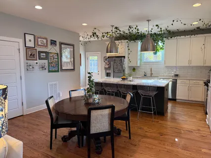 a view of a dining room with furniture and wooden floor