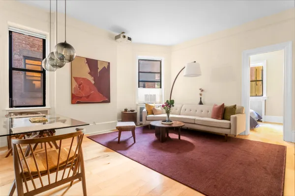 a living room with furniture a rug and a chandelier