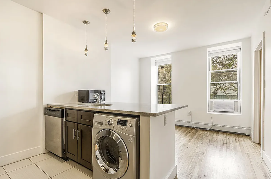 406 Monroe Street, Unit 3 Brooklyn, NY 11221 - Photo 1 of 11 a view of a kitchen with a sink dishwasher and wooden floor