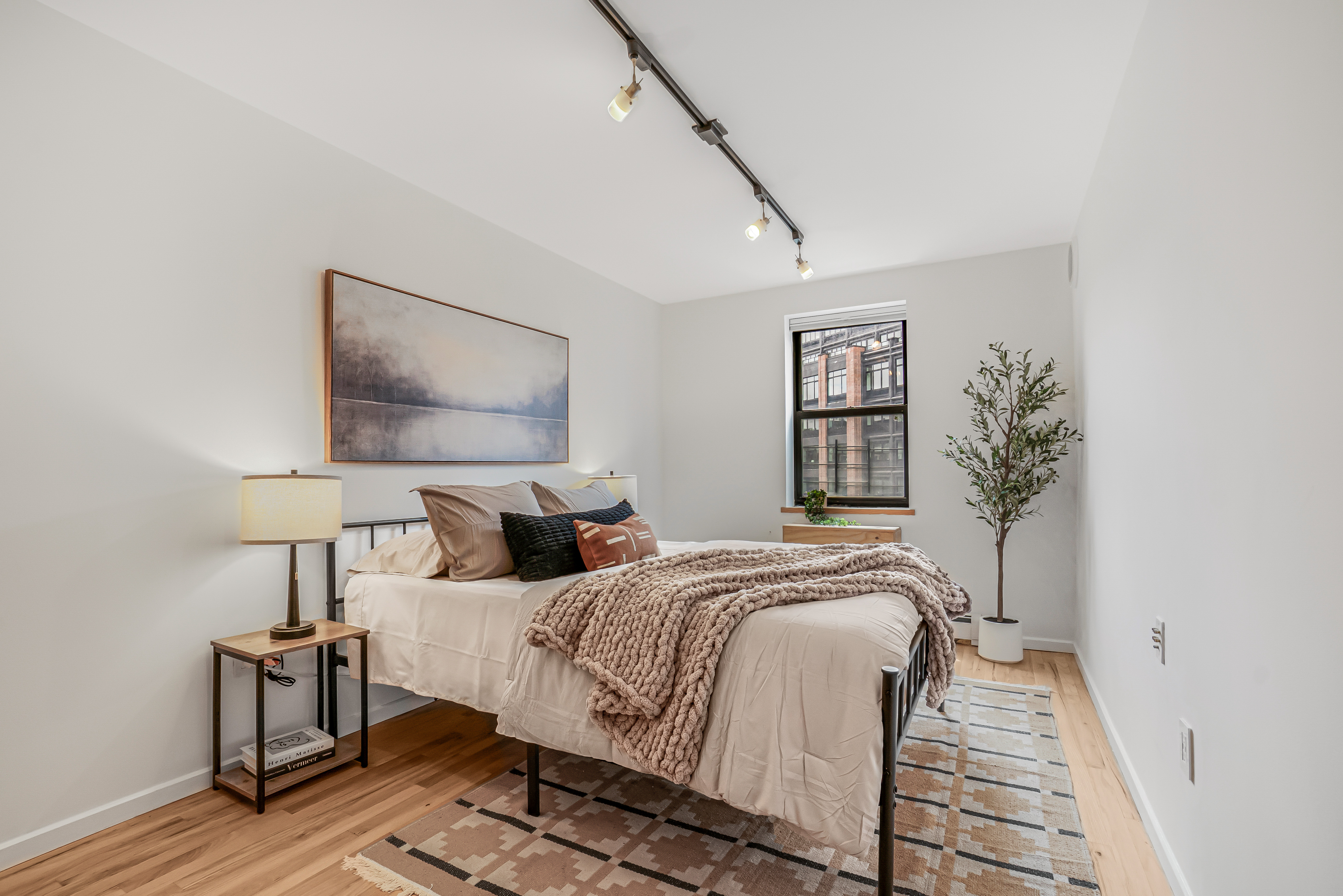 7 Gates Avenue, Unit H Brooklyn, NY 11238 - Photo 10 of 20 a bedroom with a bed and wooden floor