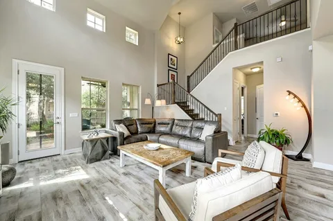a living room with furniture and wooden floor