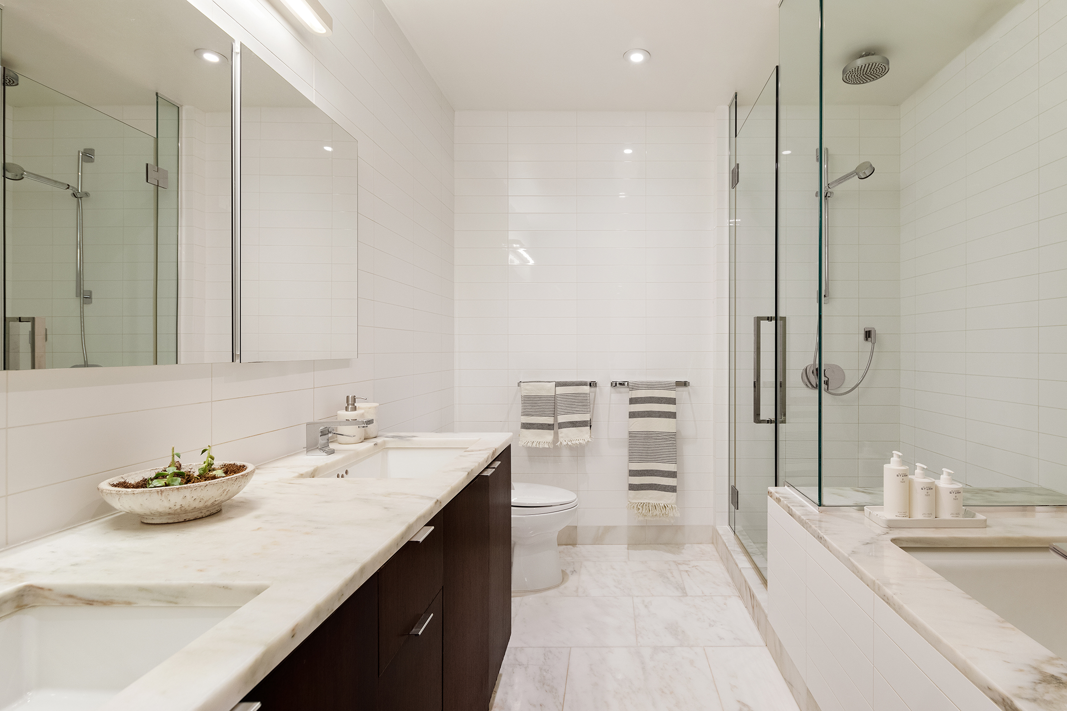 101 Warren Street, Unit 2010 Manhattan, NY 10007 - Photo 12 of 18 a spacious bathroom with a double vanity sink mirror and double