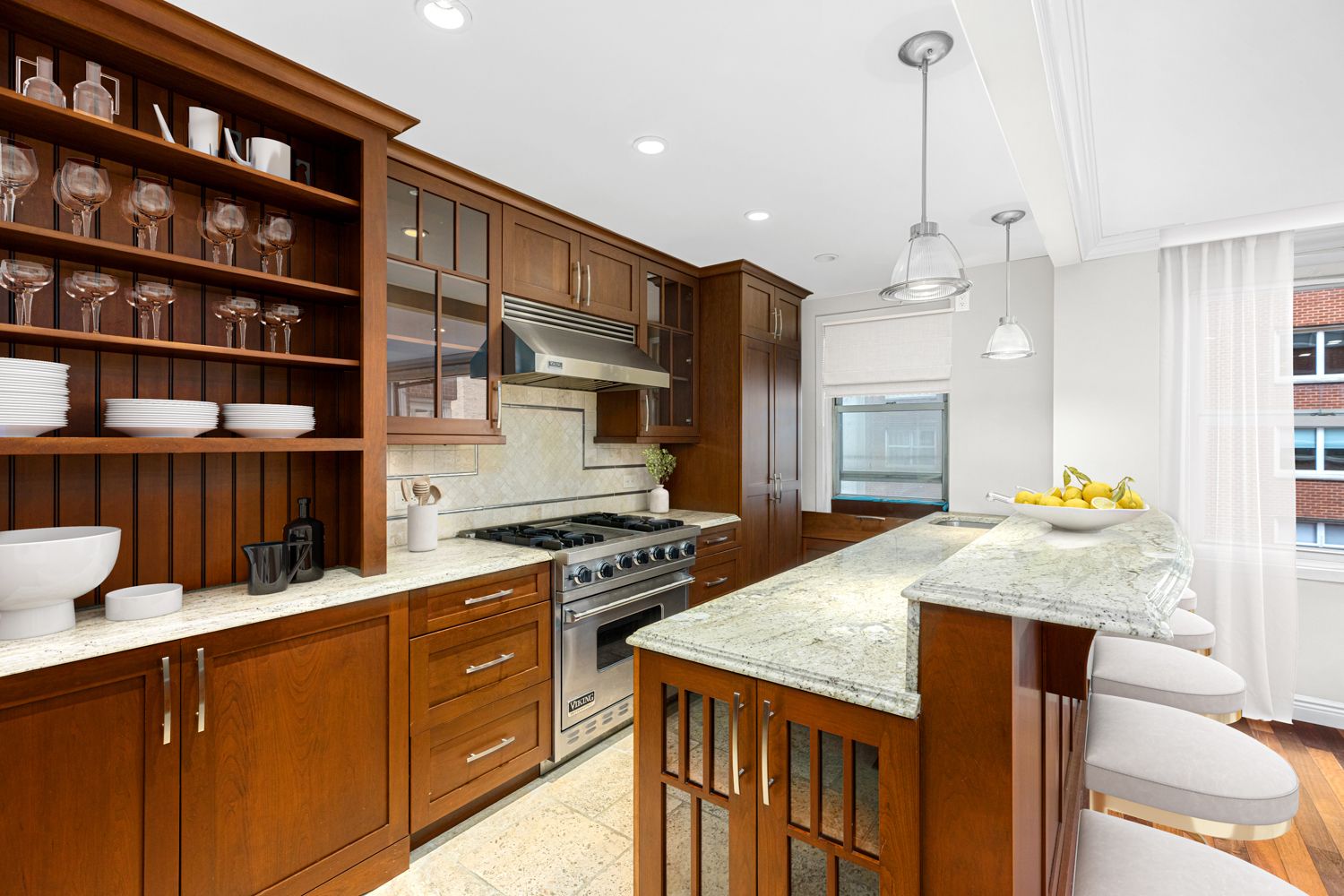 a kitchen with stainless steel appliances granite countertop a stove a refrigerator a sink and a dining table with wooden floor