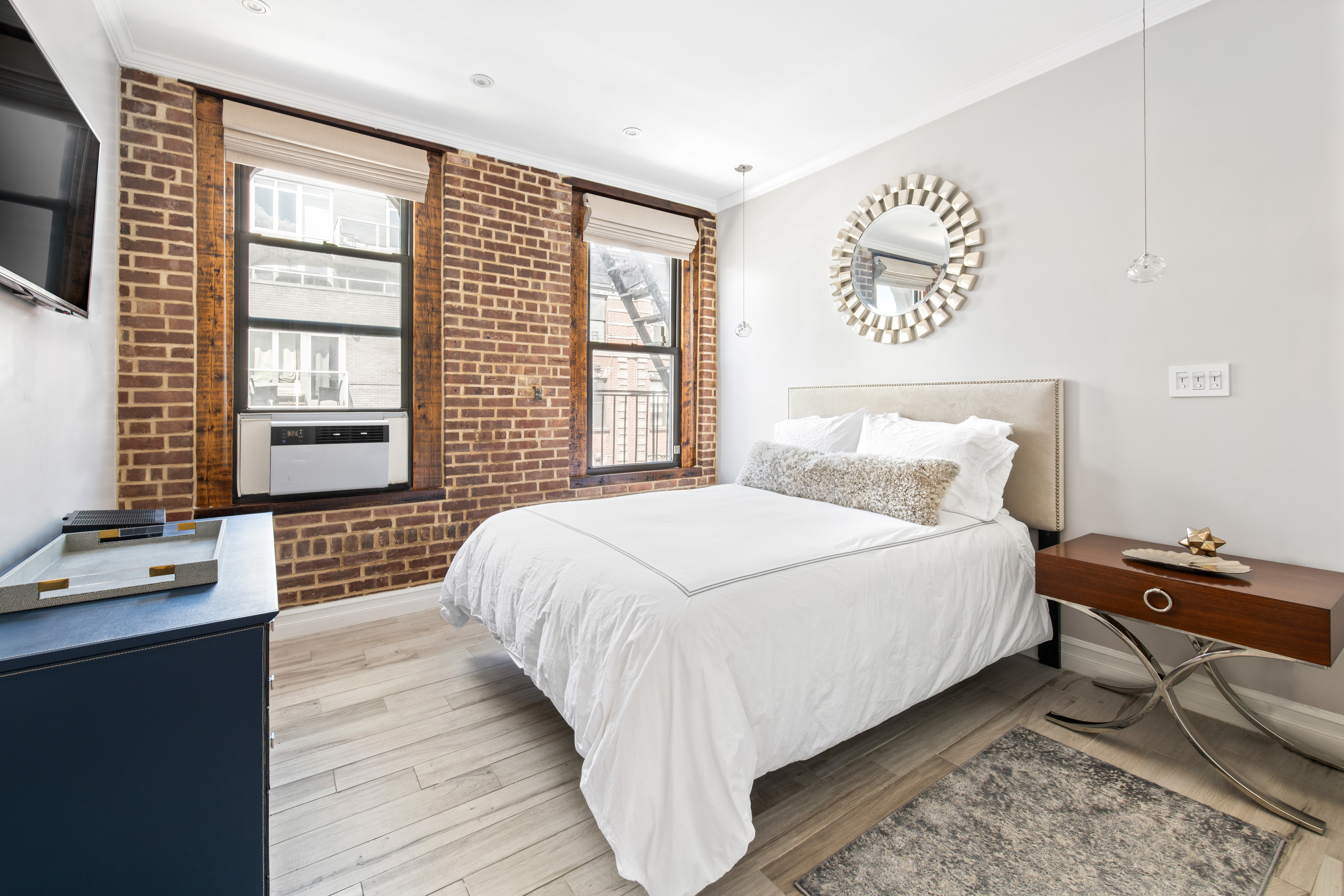 135 Ridge Street, Unit 5A Manhattan, NY 10002 - Photo 5 of 11 a bedroom with a bed and wooden floor