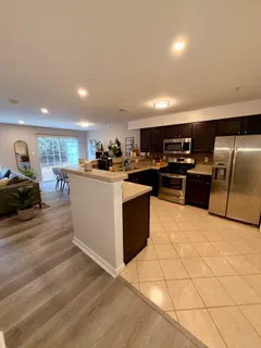 a kitchen with stainless steel appliances granite countertop a stove a sink dishwasher a refrigerator and a oven