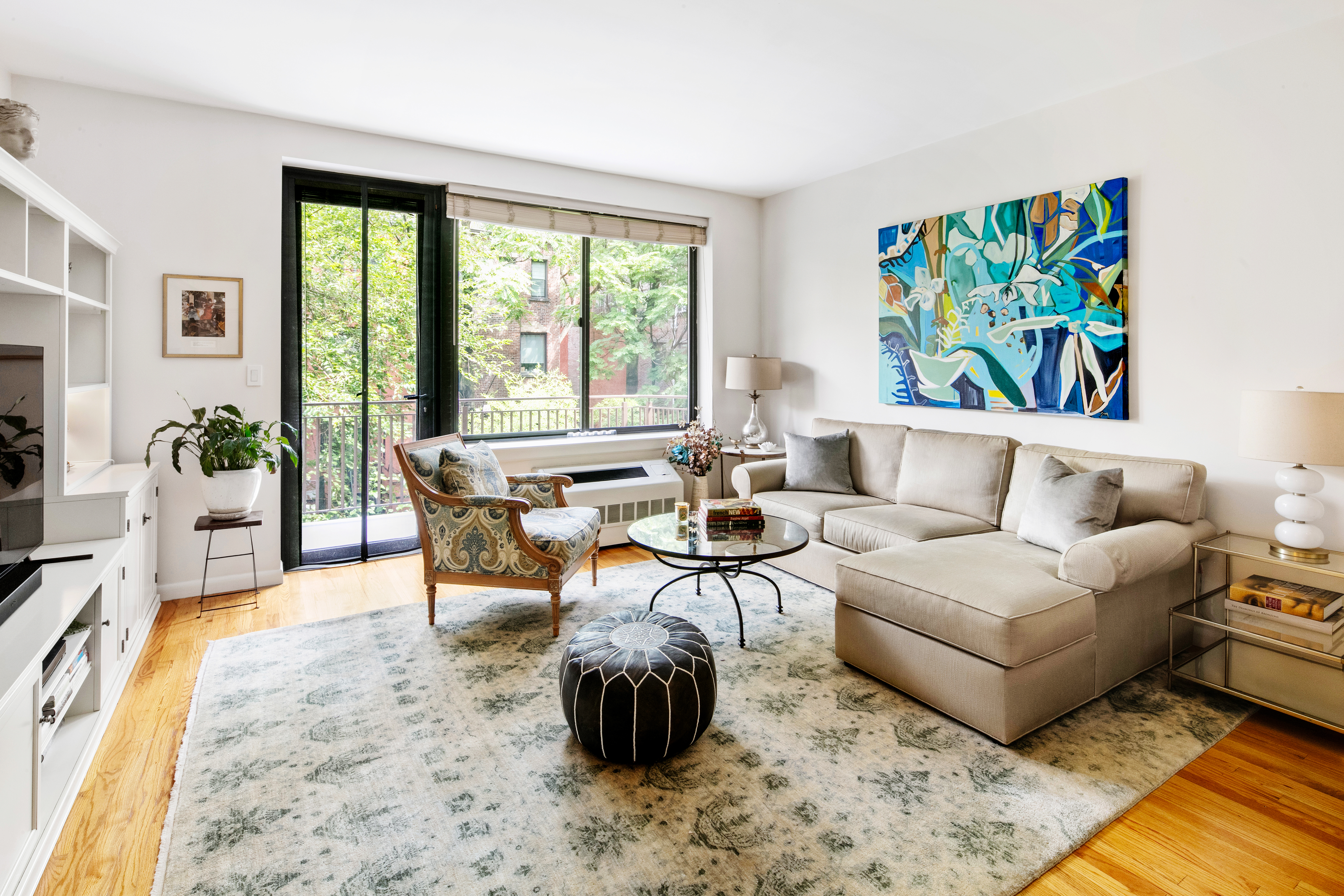 5 West 127th Street, Unit 3B Manhattan, NY 10027 - Photo 1 of 9 a living room with furniture and a large window