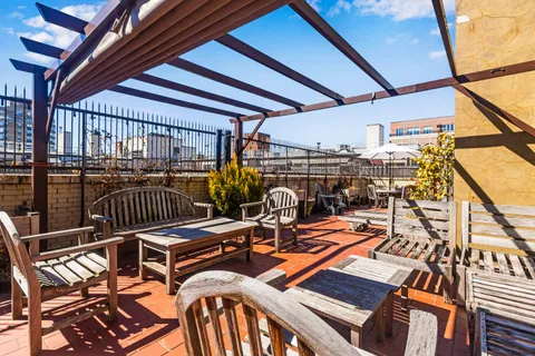 a view of a balcony with furniture and wooden floor