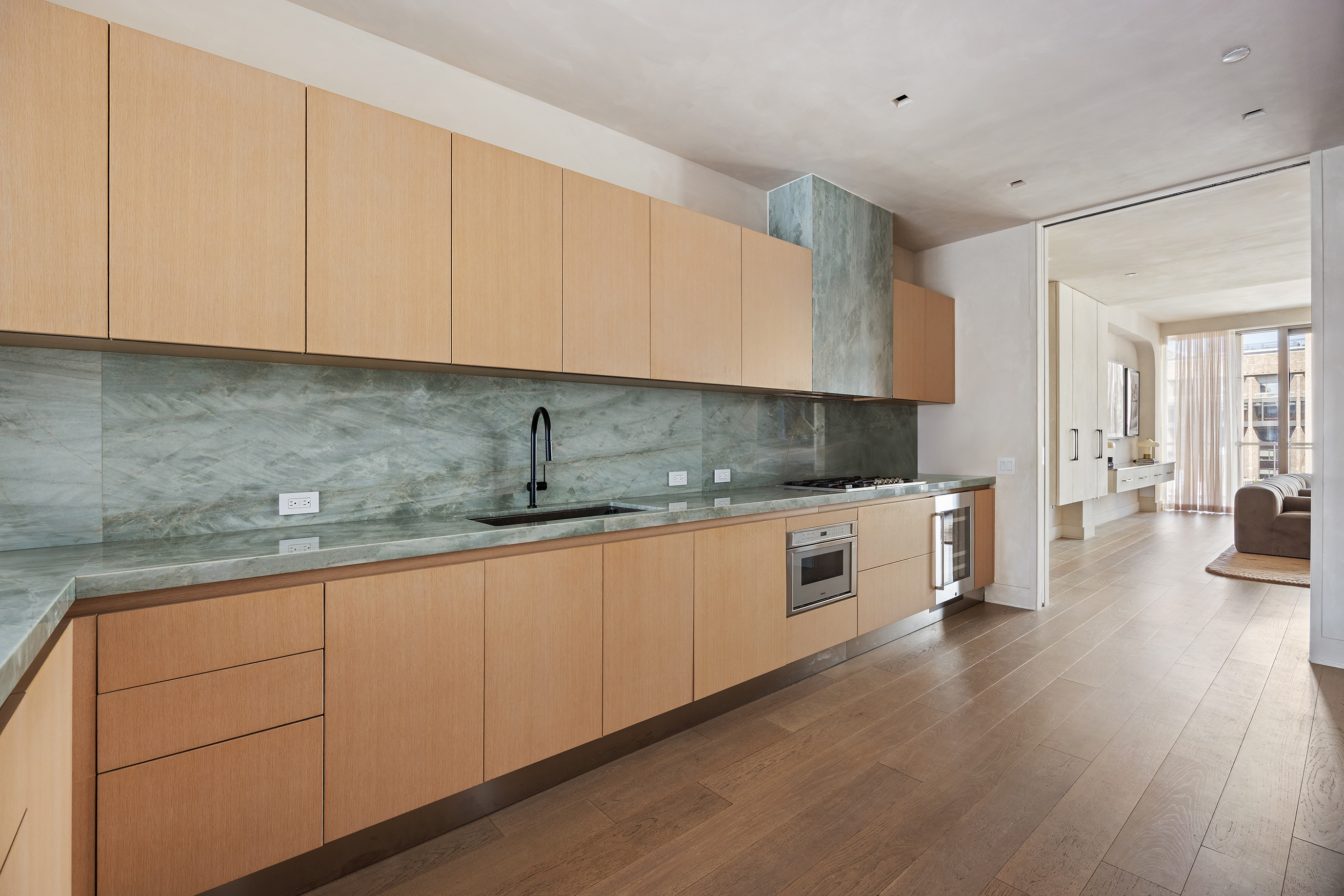 1 Great Jones Alley, Unit 10 Manhattan, NY 10012 - Photo 14 of 41 a kitchen with granite countertop white cabinets and white appliances