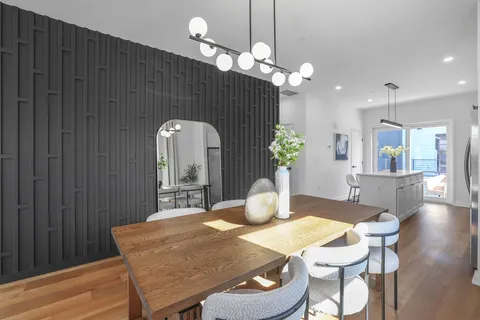 a dining room with furniture and wooden floor