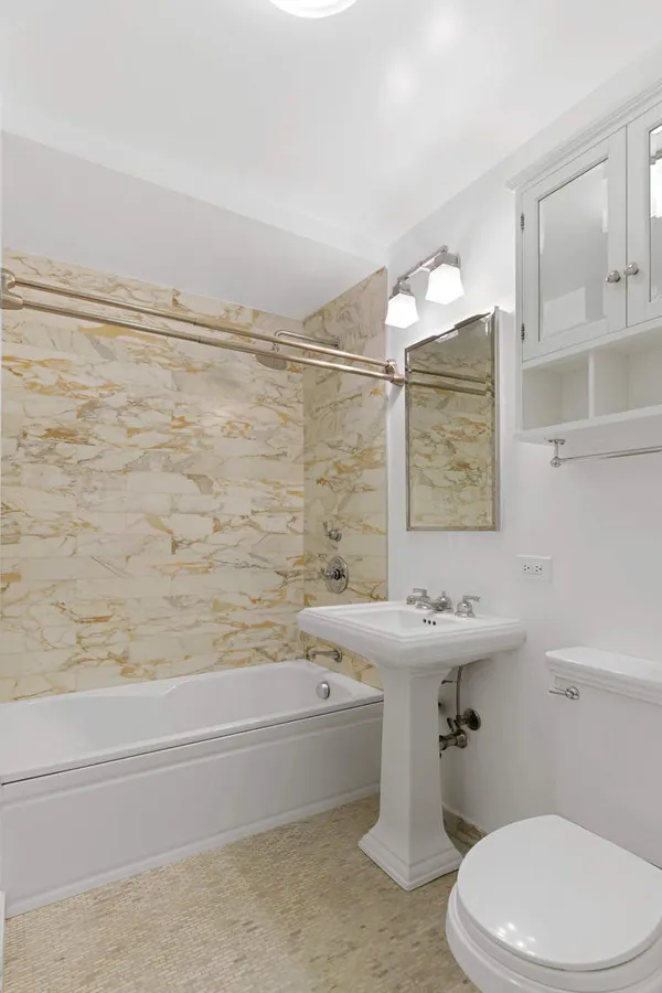 a bathroom with a sink a toilet and bathtub