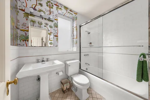 a white toilet sitting next to a bathroom sink