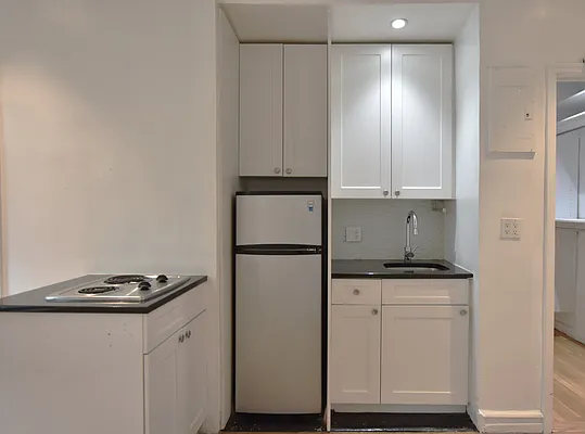 172 5th Avenue, Unit 2F Manhattan, NY 10010 - Photo 3 of 10 a kitchen with white cabinets and white appliances