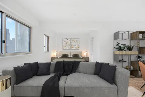 a living room with furniture and painting on the wall