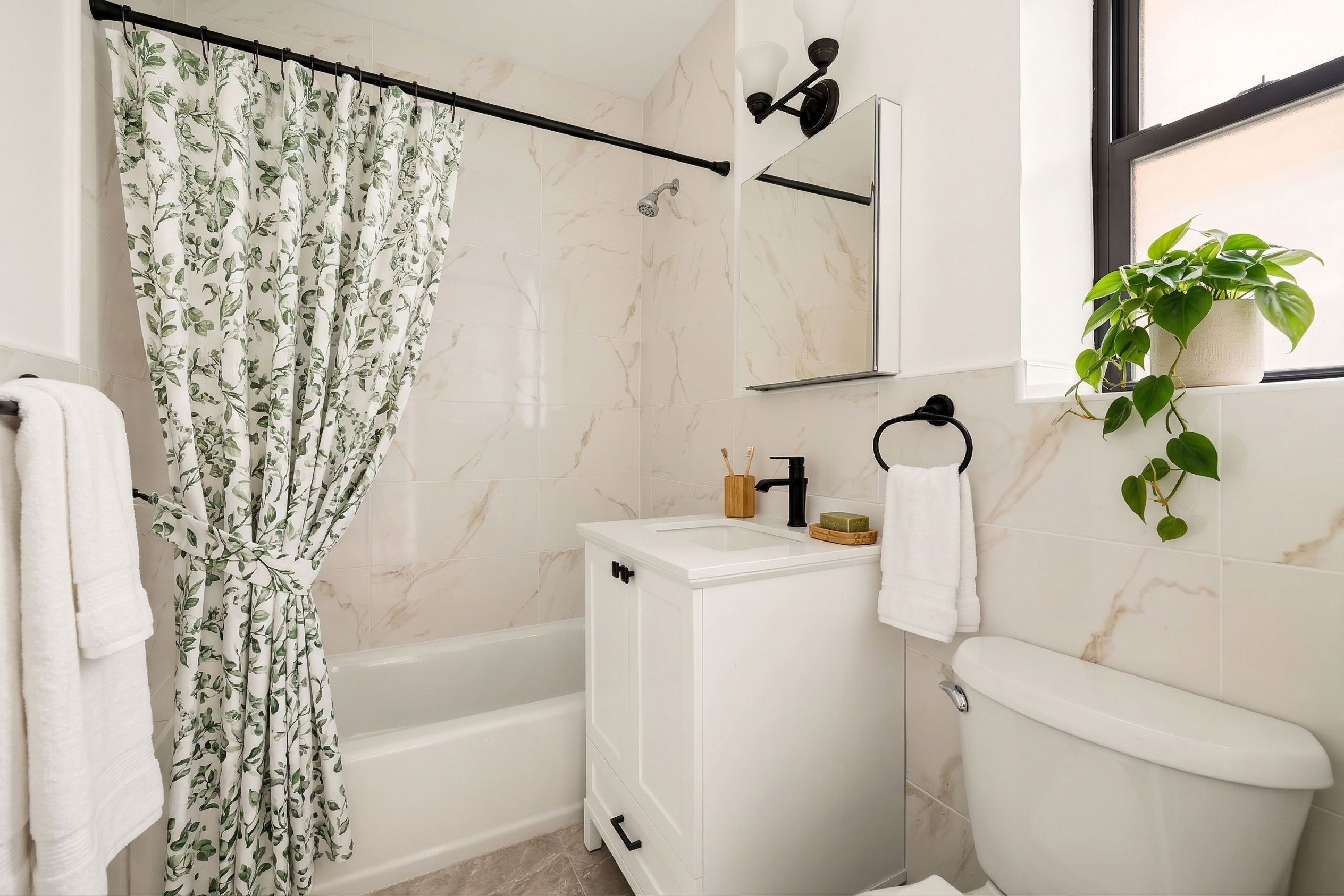 47-39 40th Street, Unit 1B Queens, NY 11104 - Photo 10 of 15 a bath room with a toilet and a shower curtain