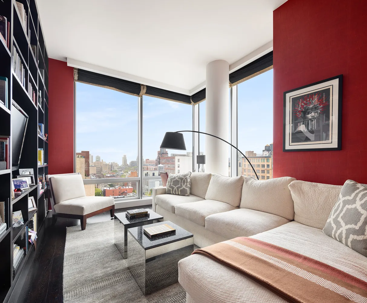 a living room with furniture and a floor to ceiling window