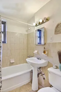 a bathroom with a sink a toilet and bathtub