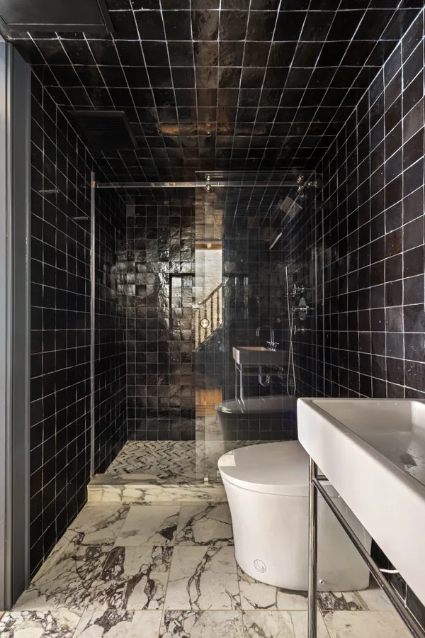 a bathroom with a bathtub a toilet a sink and shower