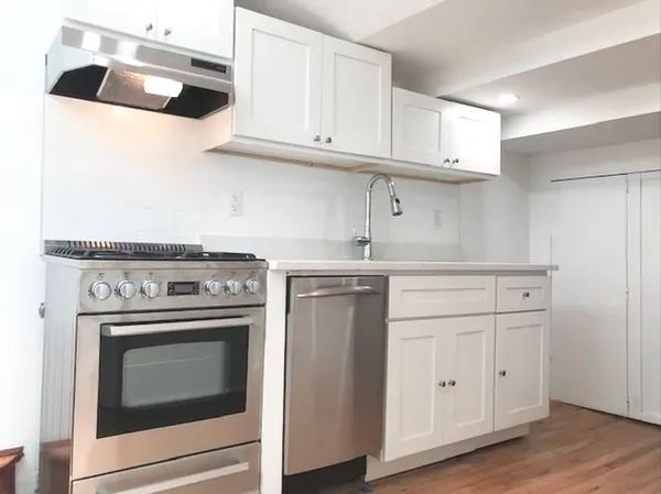 a stove top oven sitting inside of a kitchen
