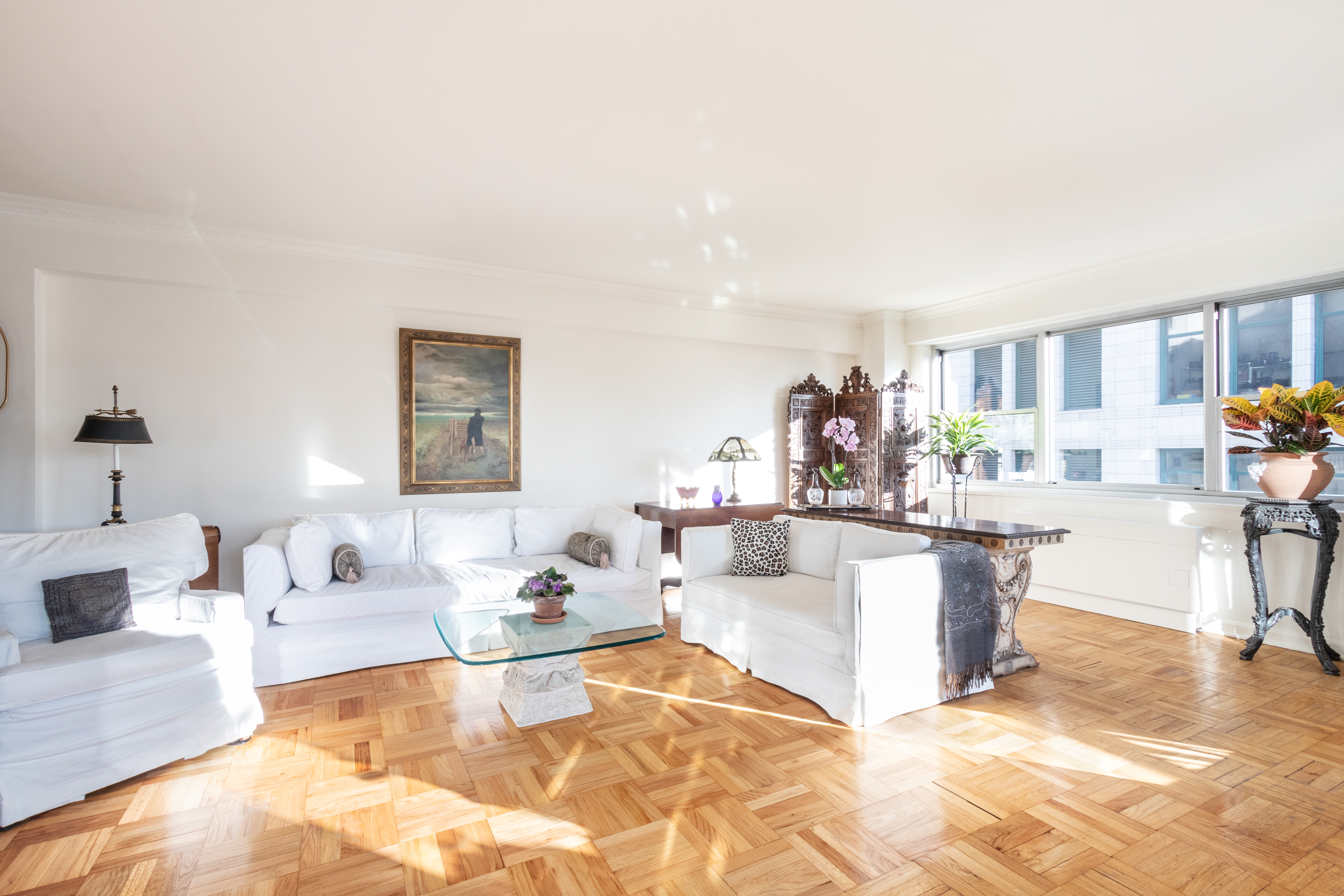 70 East 10th Street, Unit 14M Manhattan, NY 10003 - Photo 6 of 22 a living room with fireplace furniture and a large window