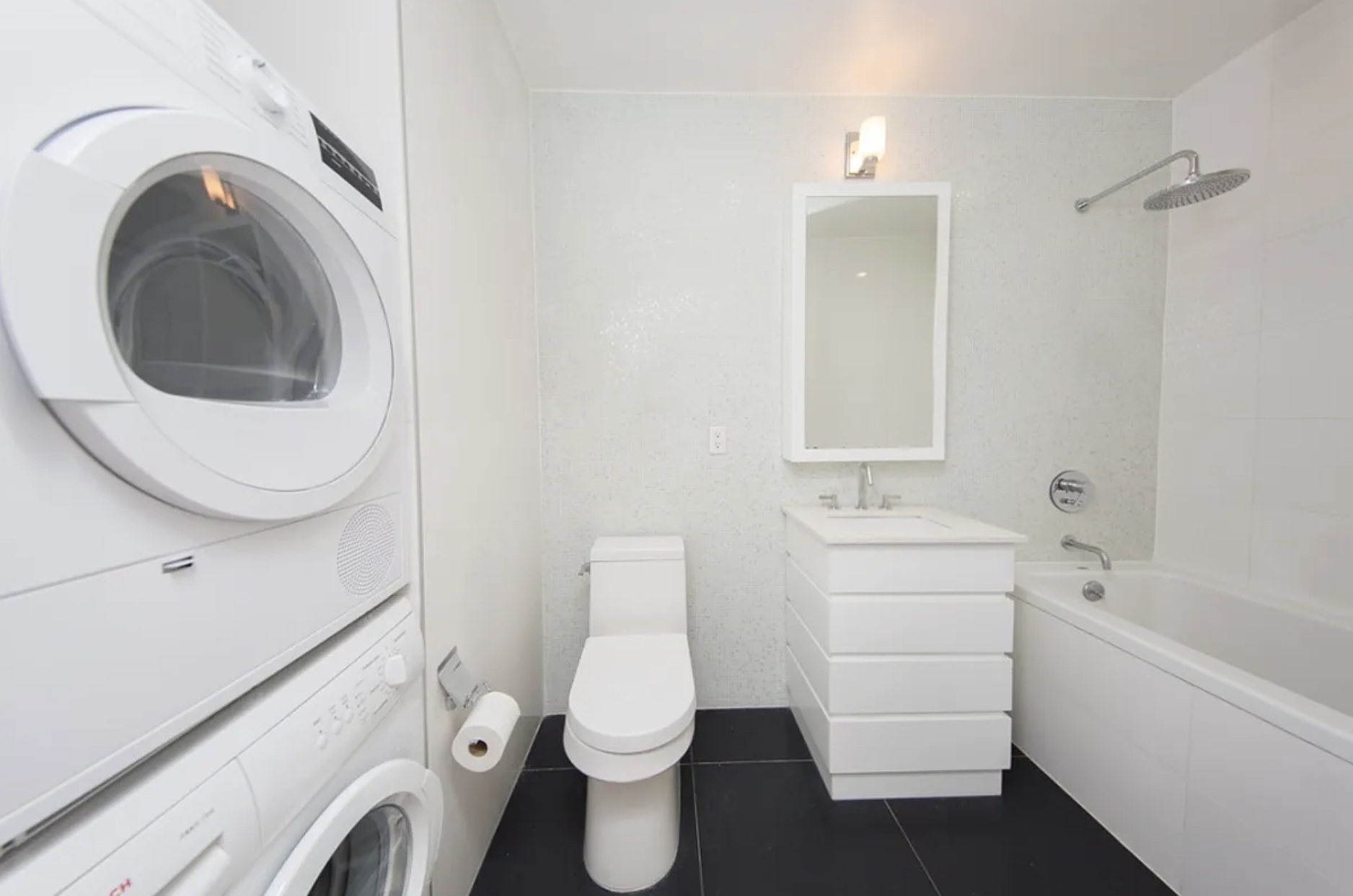 65 North 6th Street, Unit 5B Brooklyn, NY 11249 - Photo 4 of 5 a white toilet sitting next to a bathroom sink and vanity