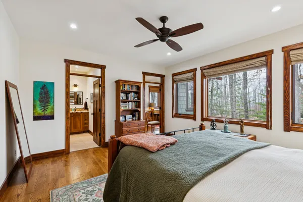 a bedroom with a bed and wooden floor