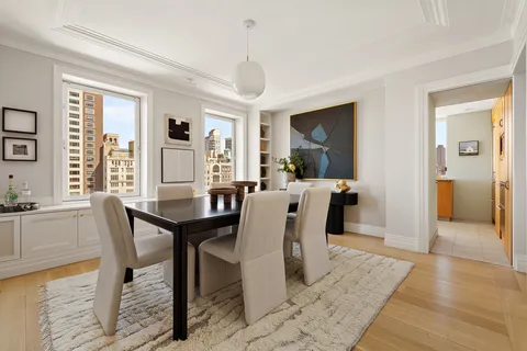 a view of a a dining room with furniture window and wooden floor
