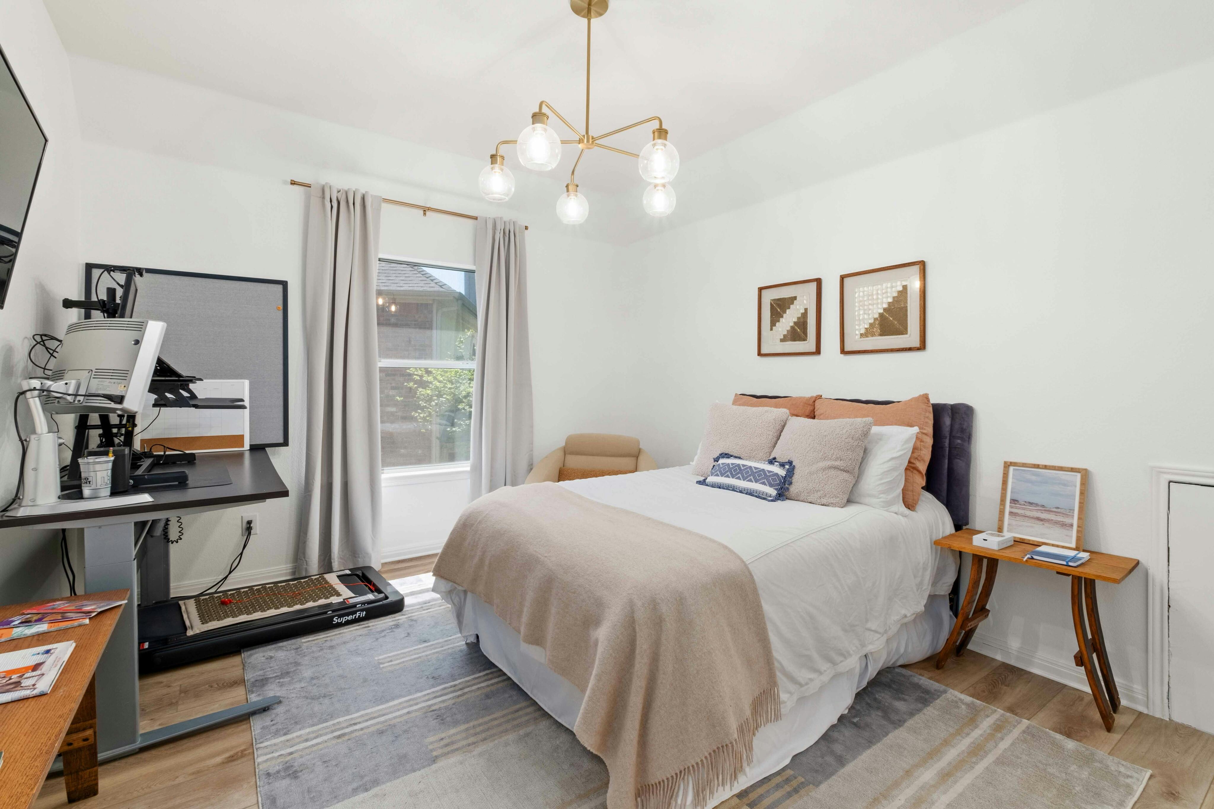 10608 Pointe View Drive Austin, TX 78738 - Photo 28 of 46 a bedroom with a bed and a chandelier