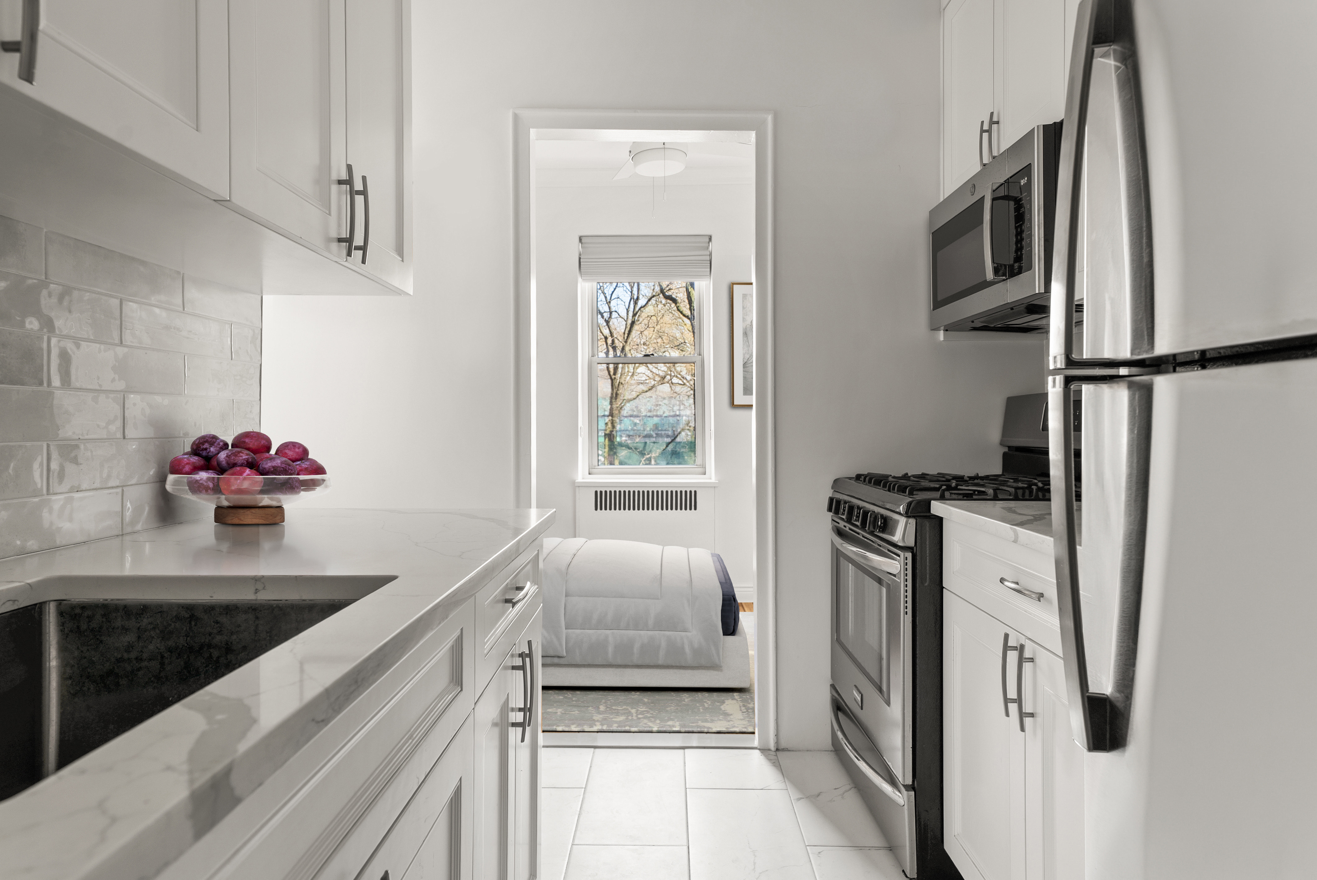 530 East 90th Street, Unit 2M Manhattan, NY 10128 - Photo 5 of 12 a kitchen with stainless steel appliances granite countertop a refrigerator and a stove