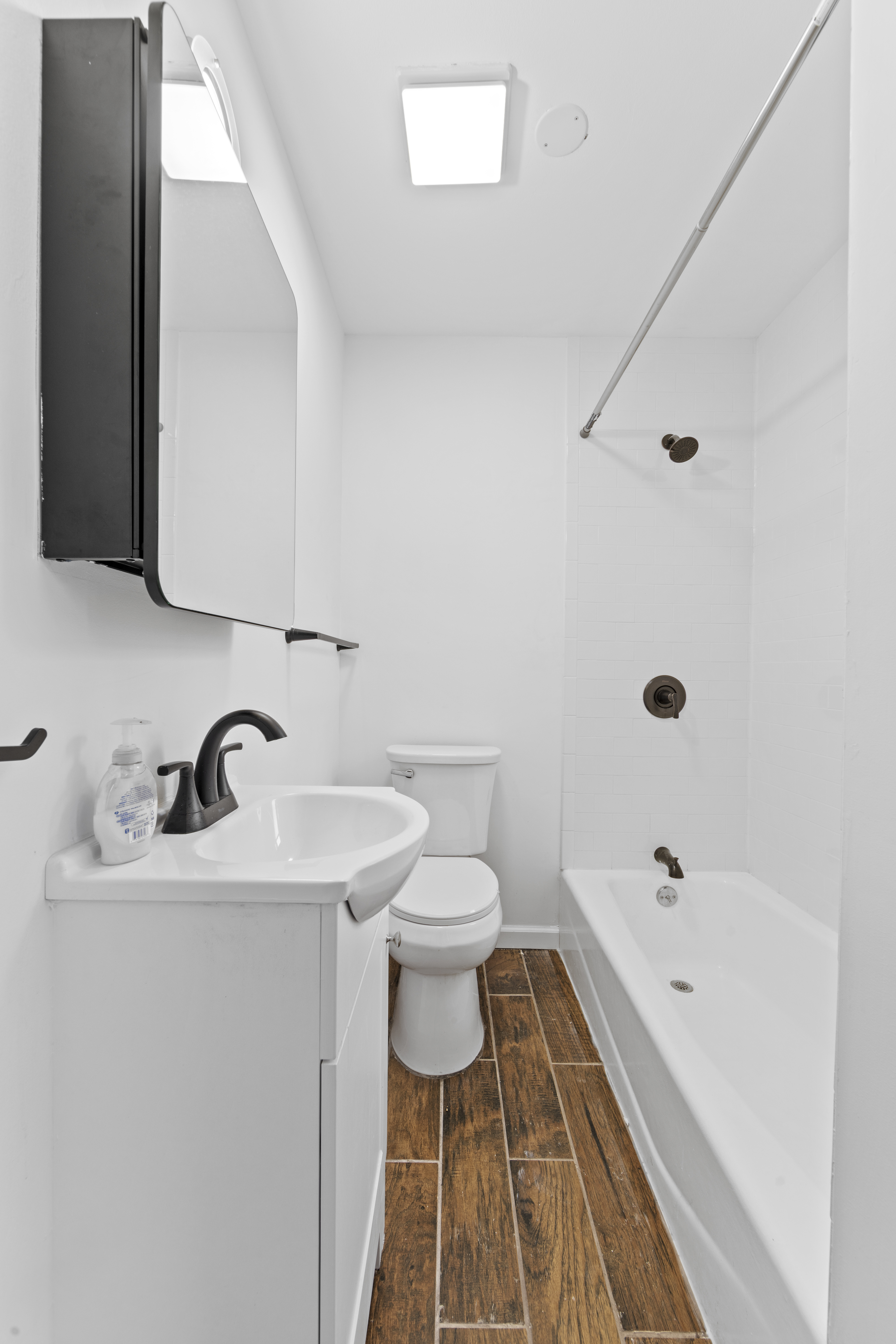1061 Fulton Street, Unit 3 Brooklyn, NY 11238 - Photo 12 of 14 a bathroom with a sink a toilet and shower
