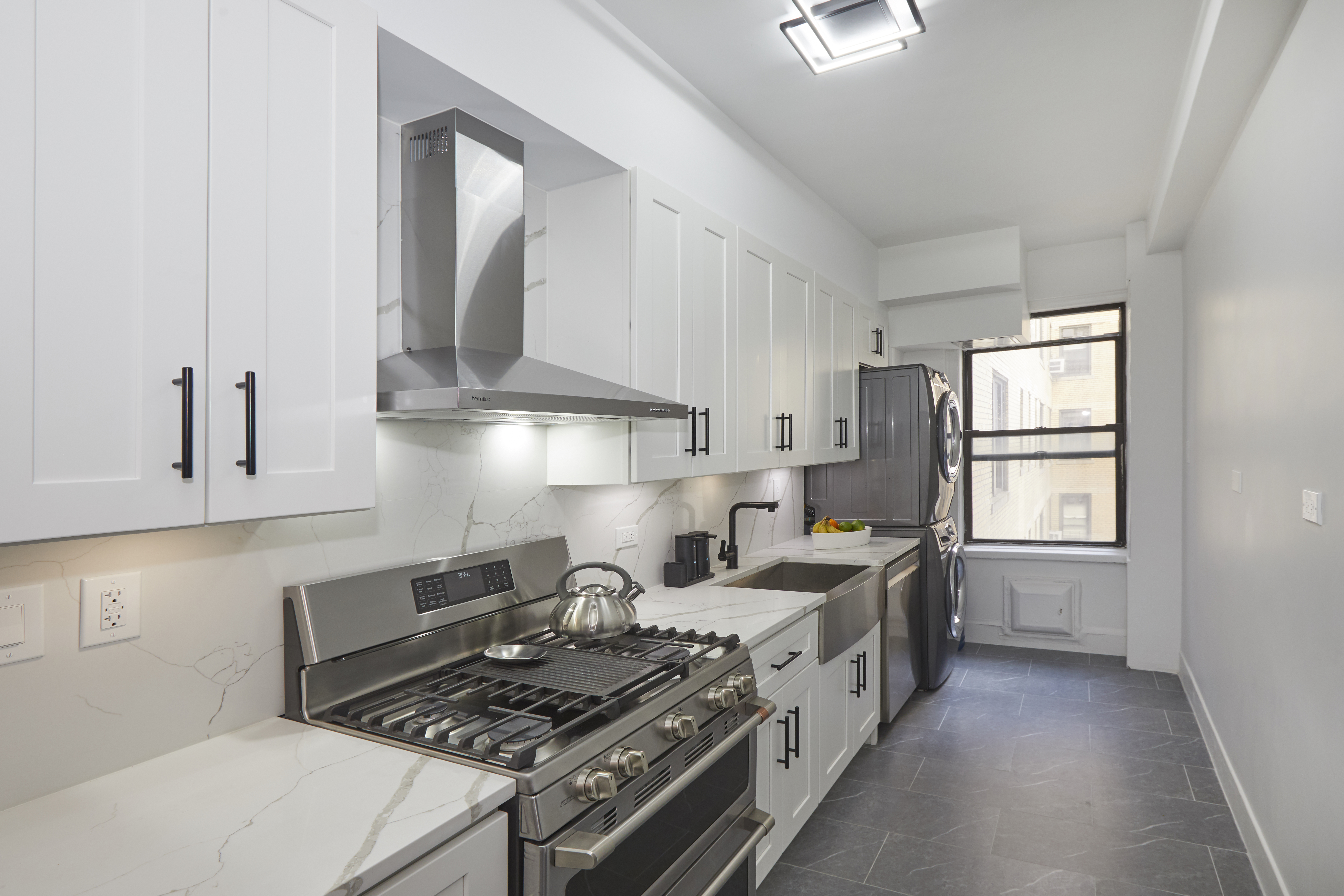 135 Eastern Parkway, Unit 9I Brooklyn, NY 11238 - Photo 1 of 17 a kitchen with a stove a sink and a window