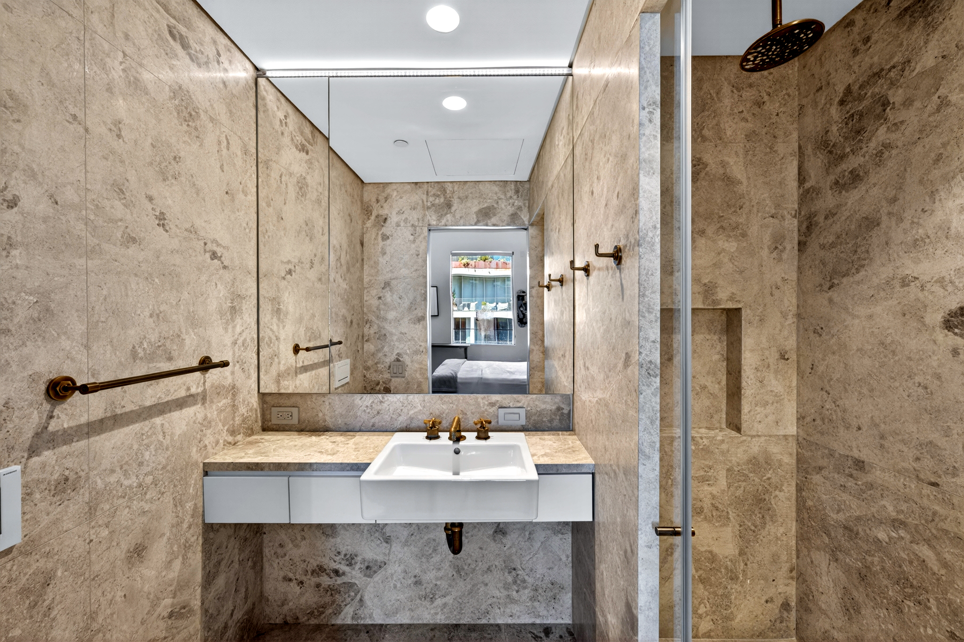 527 West 27th Street, Unit 6S Manhattan, NY 10001 - Photo 14 of 19 a bathroom with a sink a mirror and a shower