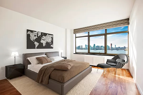 100 Morton Street, Unit 14CW Manhattan, NY 10014 - Photo 4 of 8 a bedroom with a bed and a large window