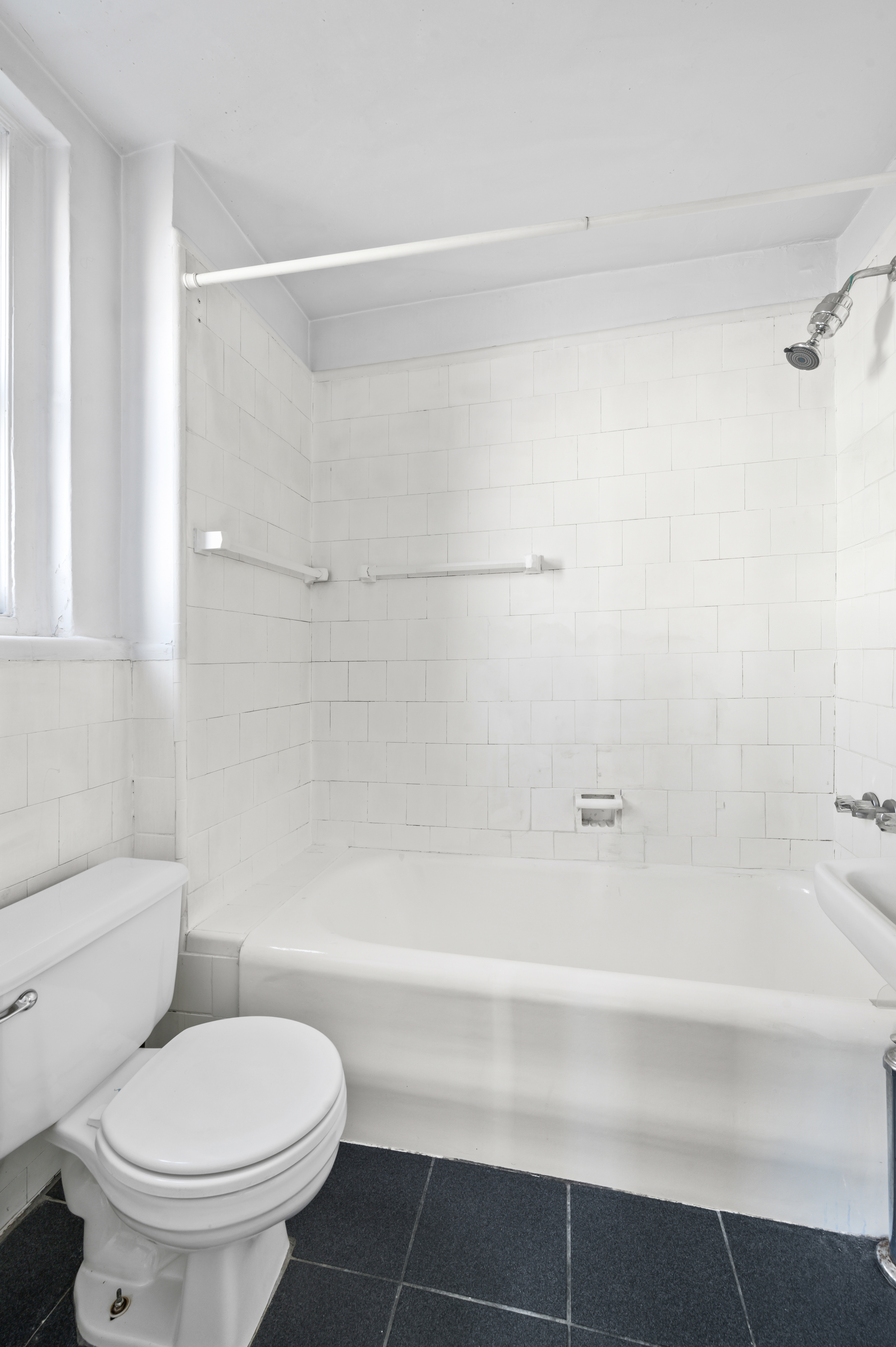 17 West 64th Street, Unit 6E Manhattan, NY 10023 - Photo 3 of 6 a bathroom with a toilet and a bathtub